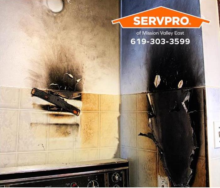 The walls around a stove are damaged by a grease fire.