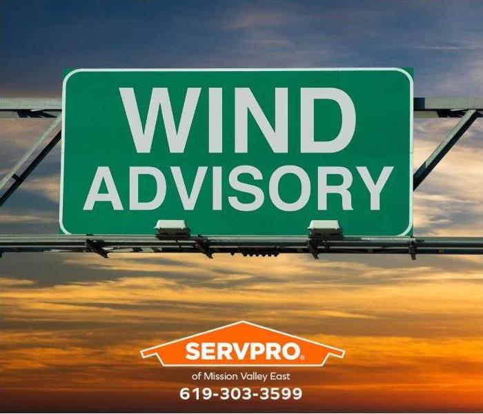 A sign reading “wind advisory” is shown.